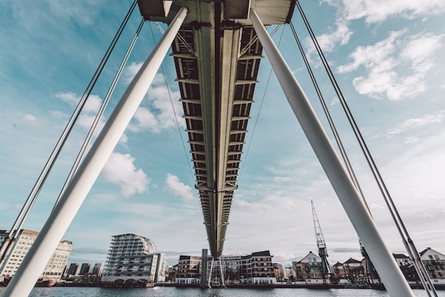 A modern bridge under construction showcasing steel framework and concrete pillars.