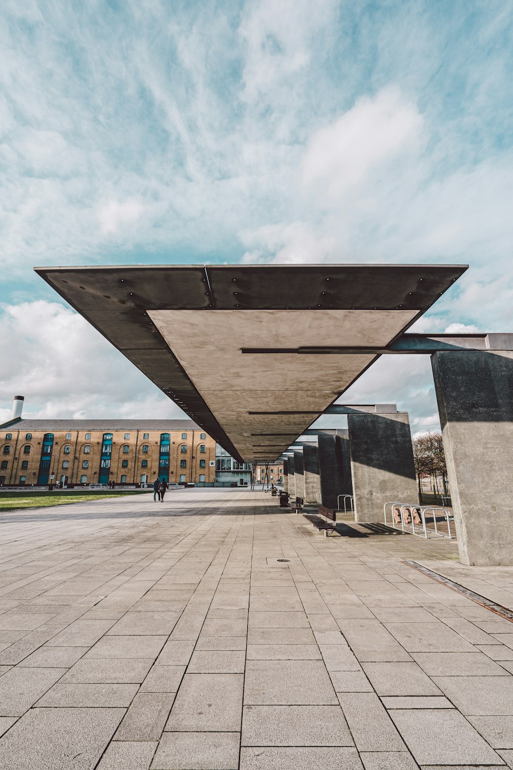 brown and gray concrete building under white clouds during daytime