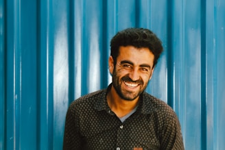 man in black and white button up shirt smiling