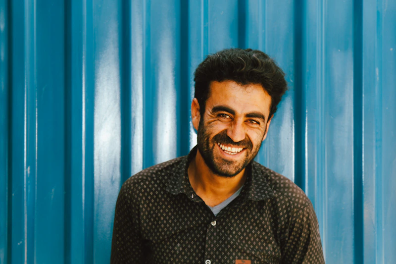 man smiling confidently in black and white shirt