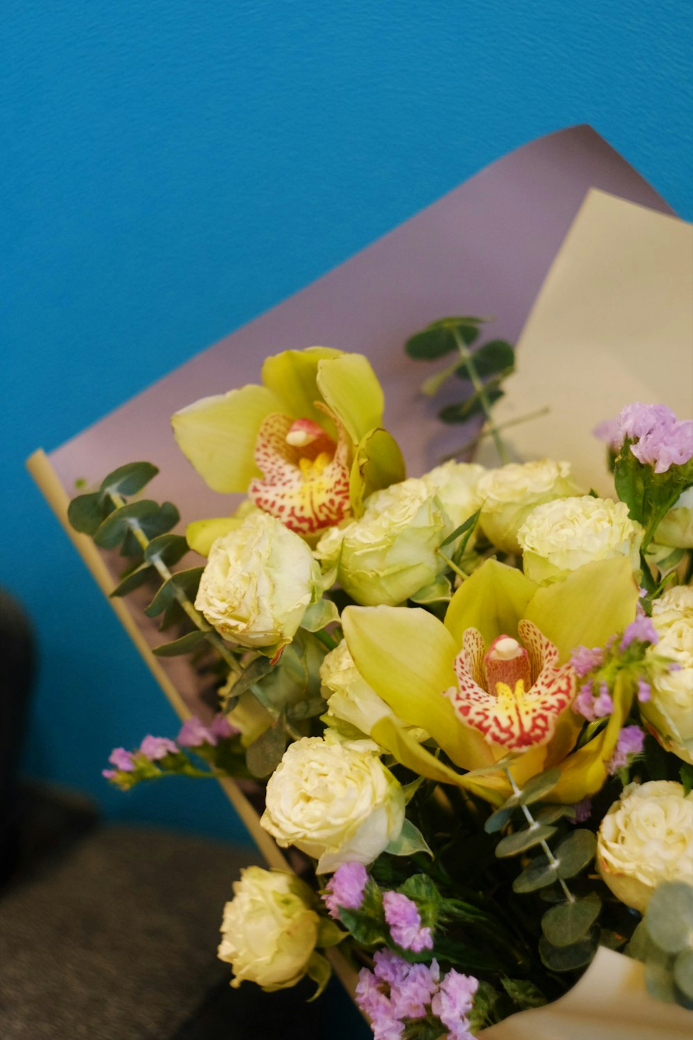 yellow roses bouquet on purple surface