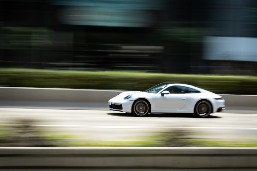 white coupe on road during daytime