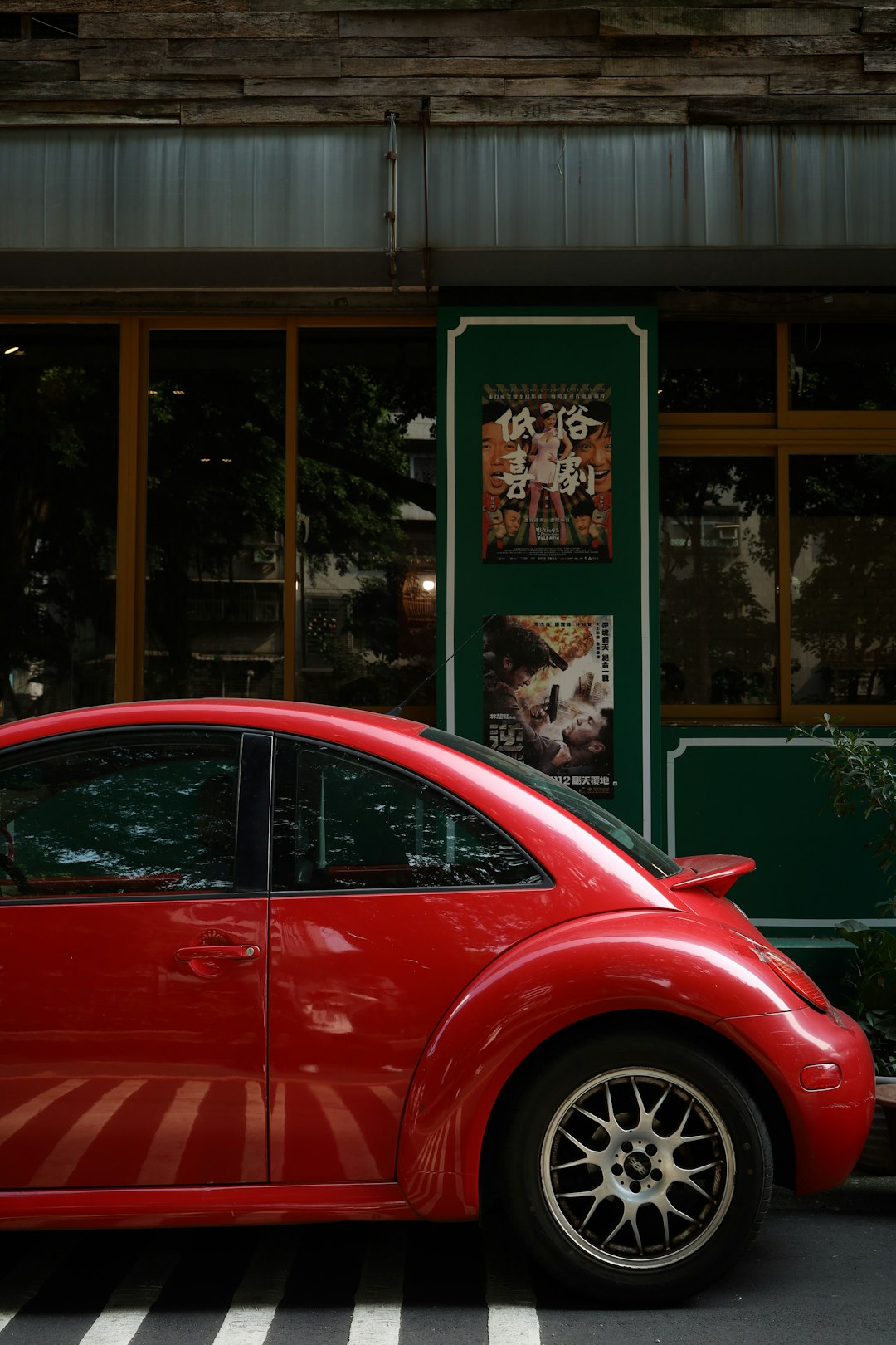 red car parked in front of store