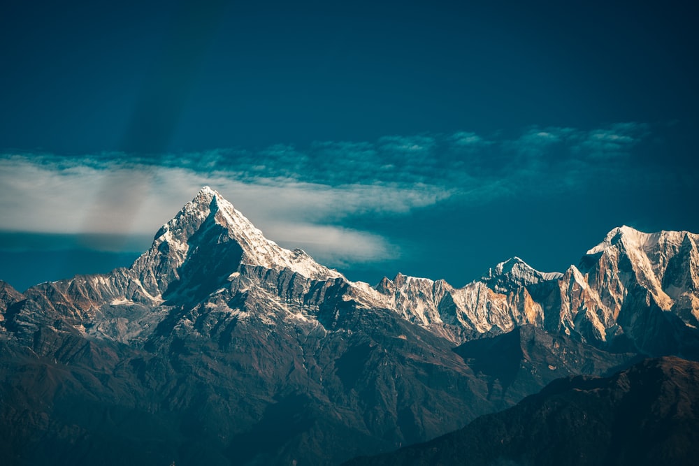 snow covered mountain under blue sky