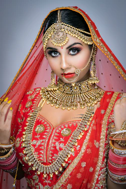 woman in red and gold sari dress