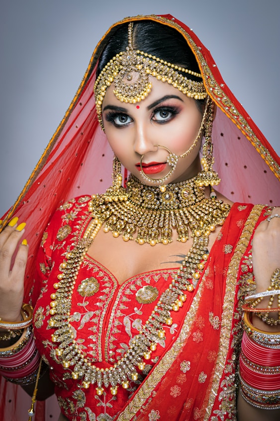 woman in red and gold sari dress