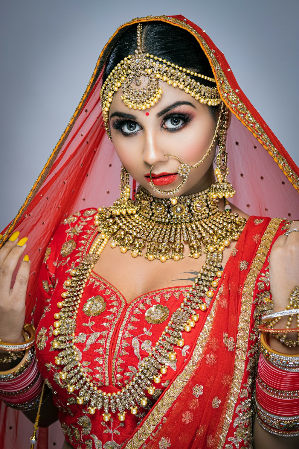 woman in red and gold sari dress