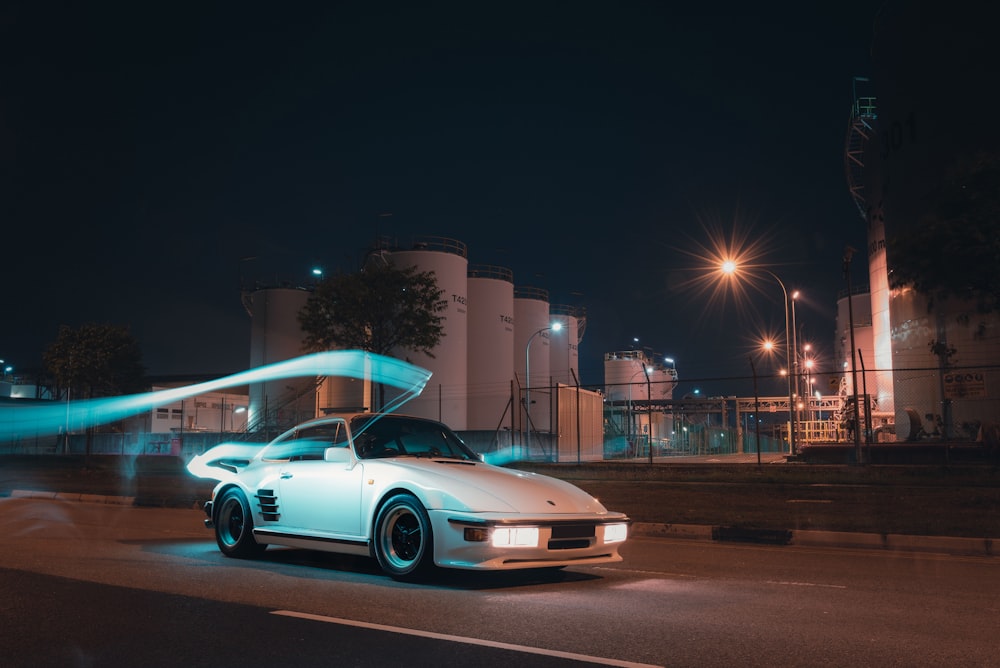 white coupe on road during night time