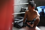 Boxing shorts and hand wraps neatly arranged on a bench.