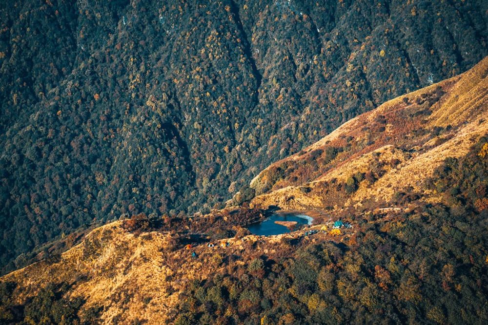 blue water on brown rocky mountain during daytime