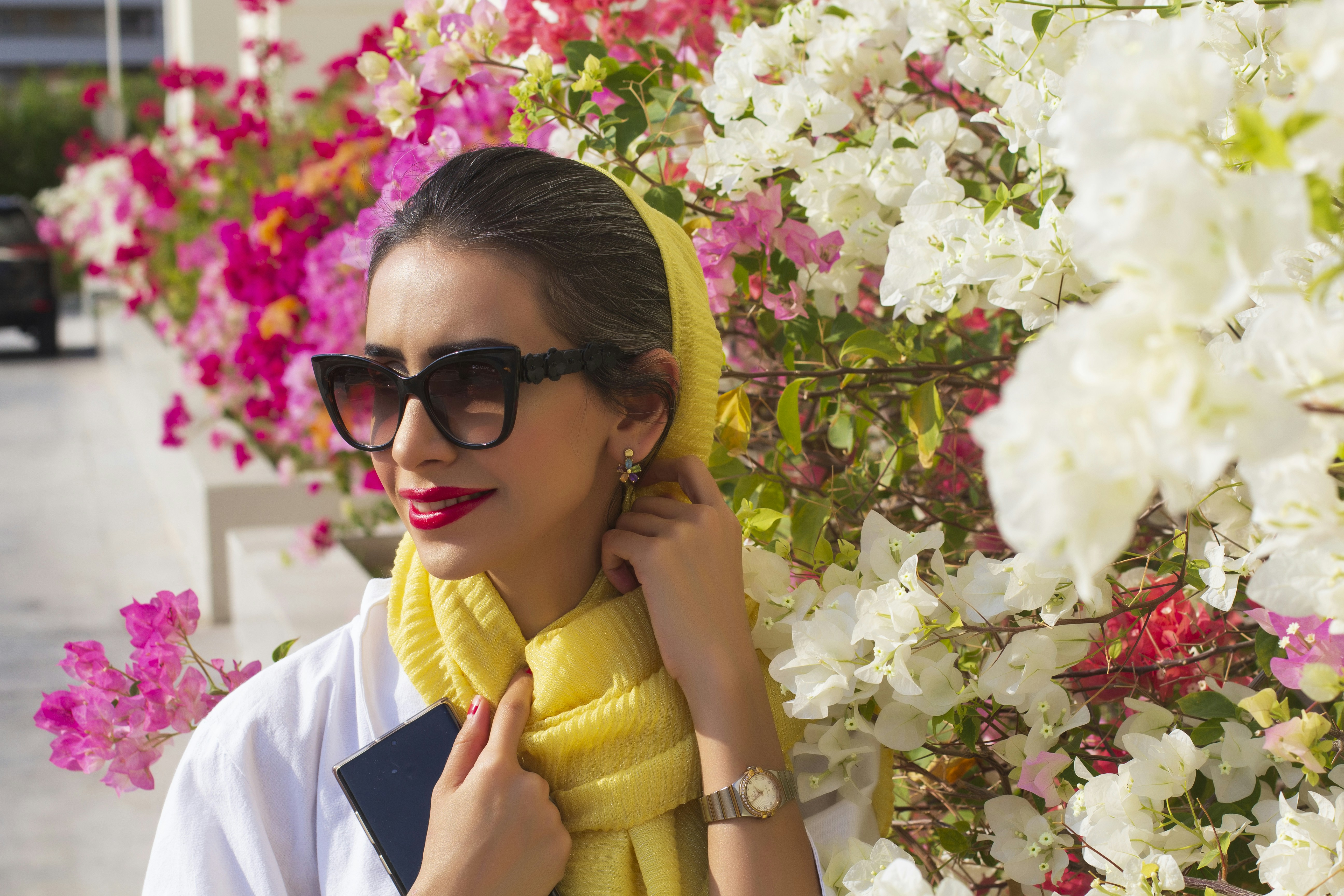 woman in white shirt wearing black sunglasses and yellow hijab