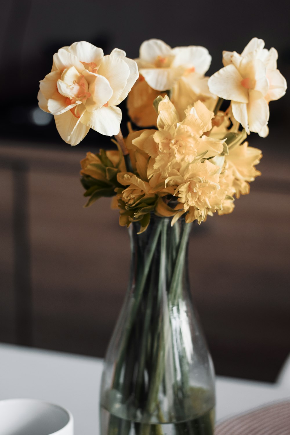 white flowers in clear glass vase