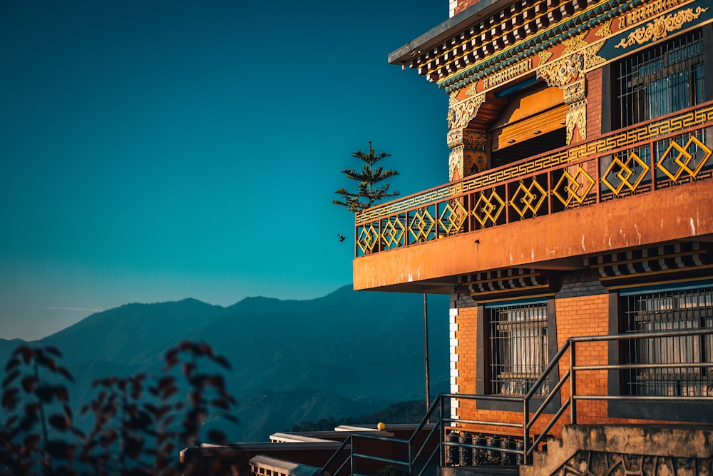 brown wooden building near mountain during daytime