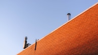 A clean, freshly swept brick chimney glowing in natural light.