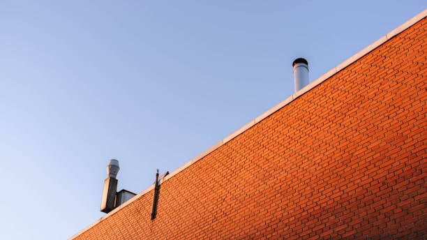Close-up of a clean chimney flue with sunlight highlighting the smooth bricks.