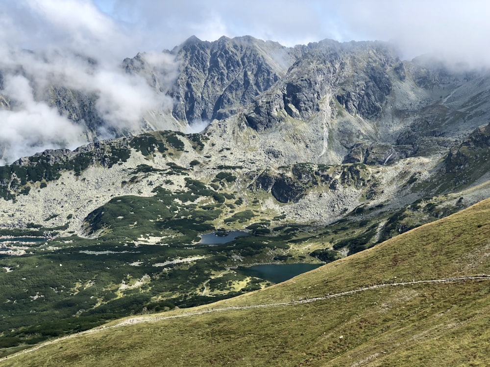 green and gray mountain under white clouds during daytime