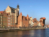 brown concrete building beside body of water during daytime