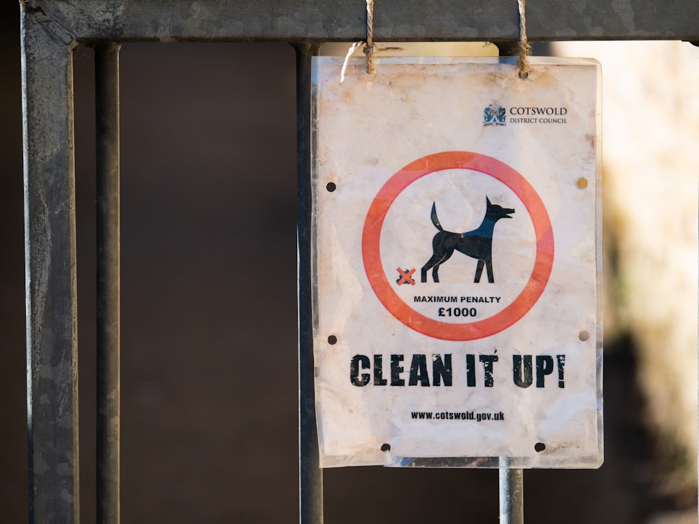 A public street sign warning you of a potential fine if your dog droppings are not cleaned up