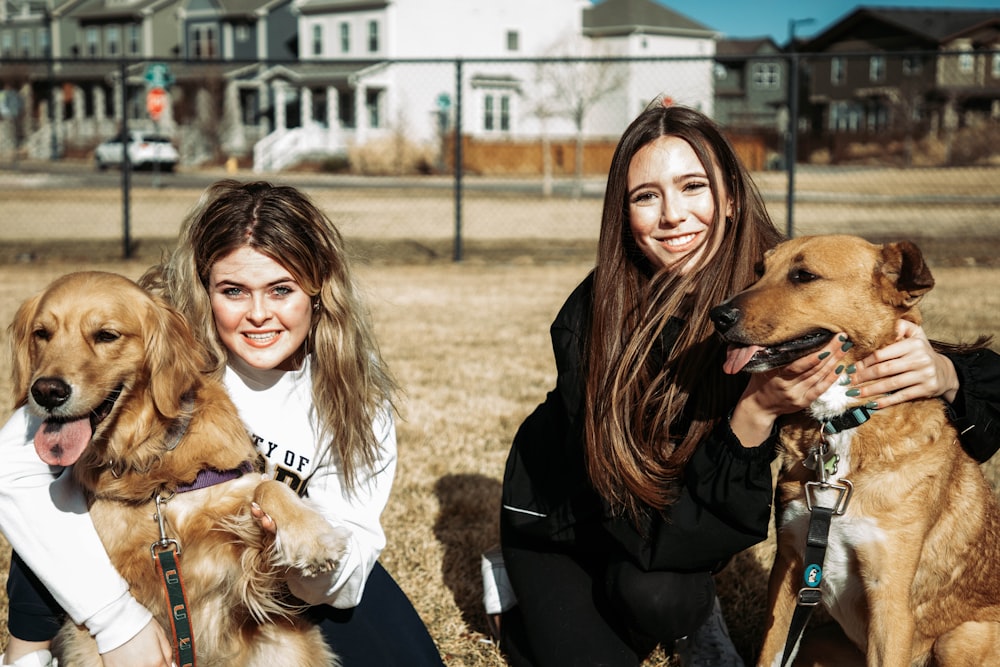 woman in black long sleeve shirt holding brown long coated dog