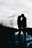 A romantic couple portrait framed by twilight and subtle violet hues.