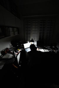 person sitting on chair in front of computer