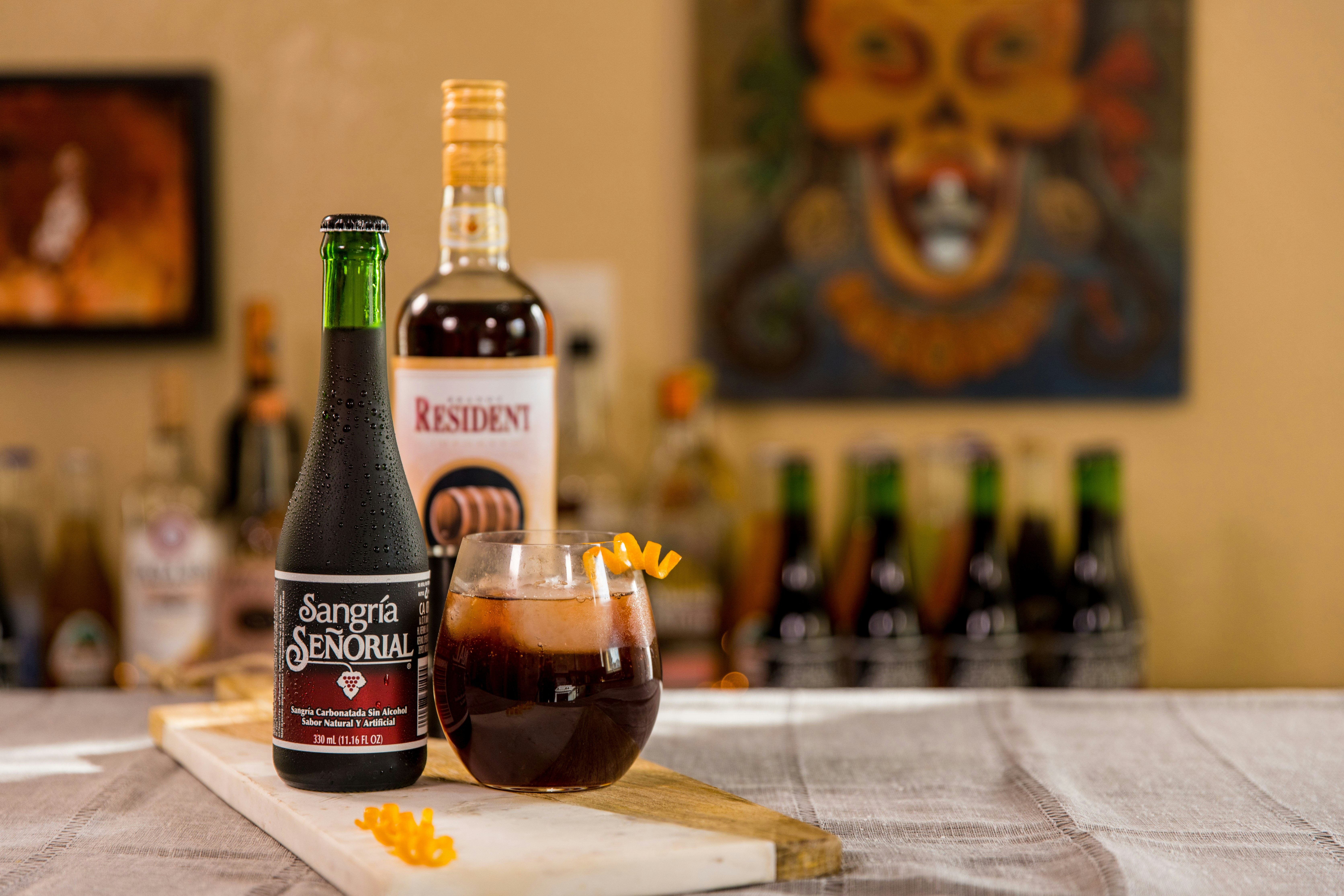black glass bottle beside clear drinking glass