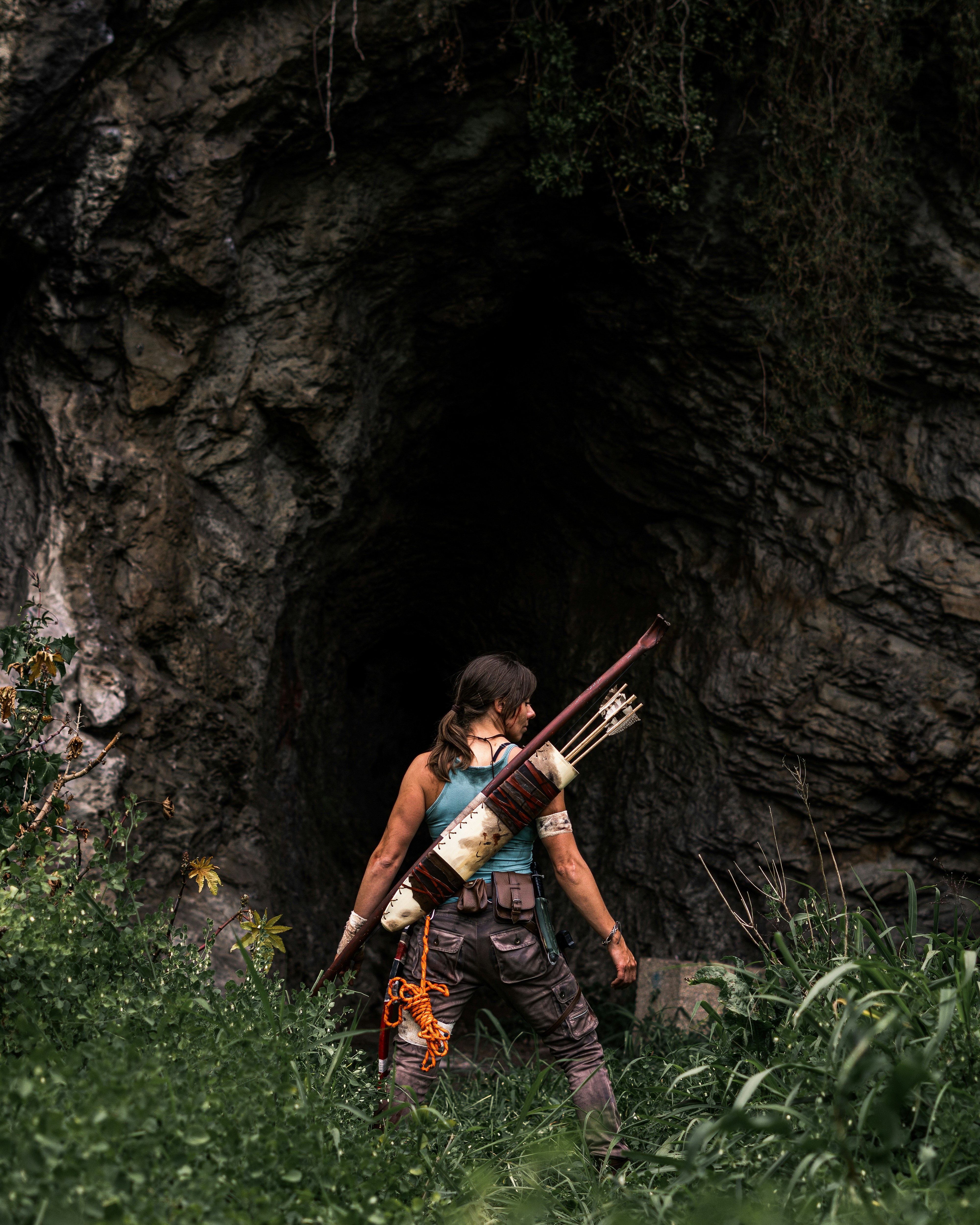woman in black tank top and gray pants holding red and black stick