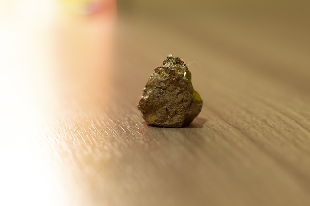 green and brown stone on brown wooden table