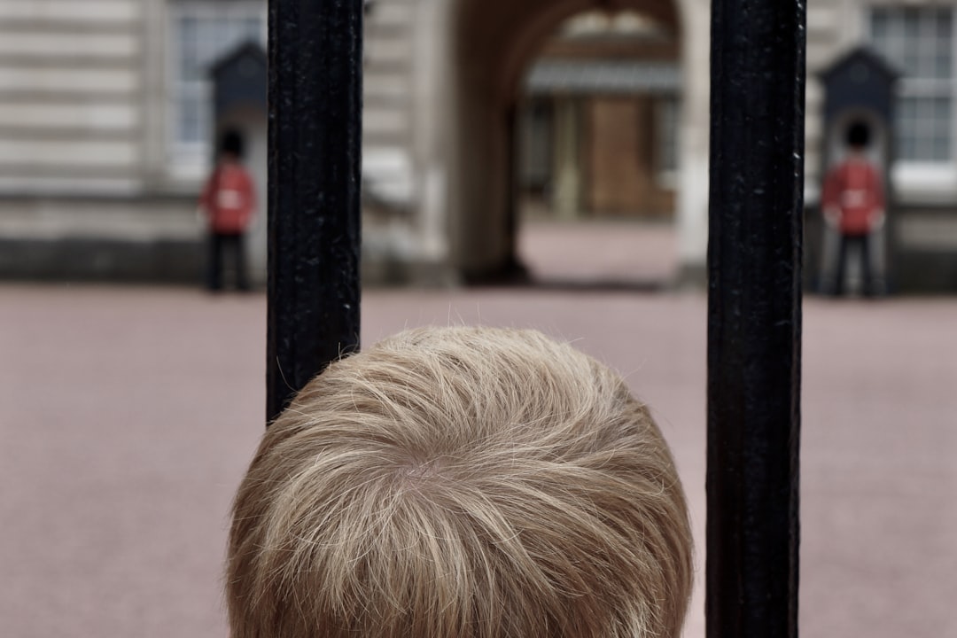 person with blonde hair looking at the window