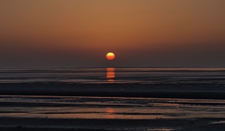 sunset over the sea with beach