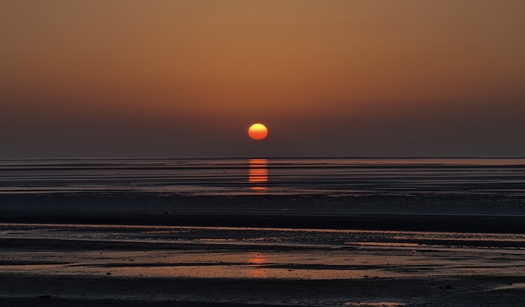 sunset over the sea with beach