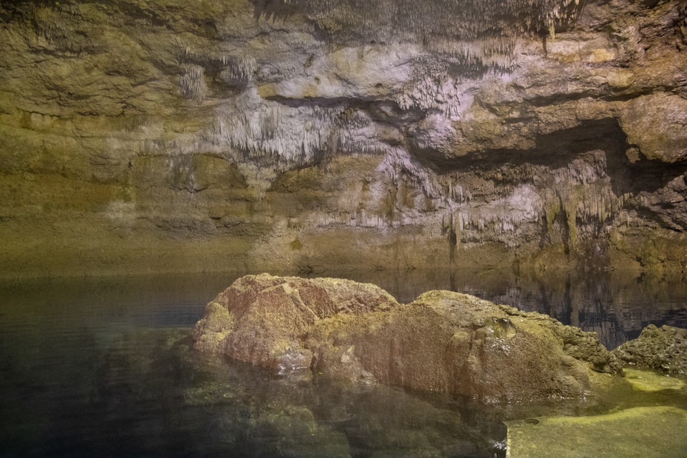 brown rock formation near body of water during daytime