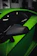 Close-up of a shiny aftermarket side mirror installed on a black sports car.