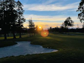 Sunset view over the golf course highlighting the serene and elegant atmosphere of the club.