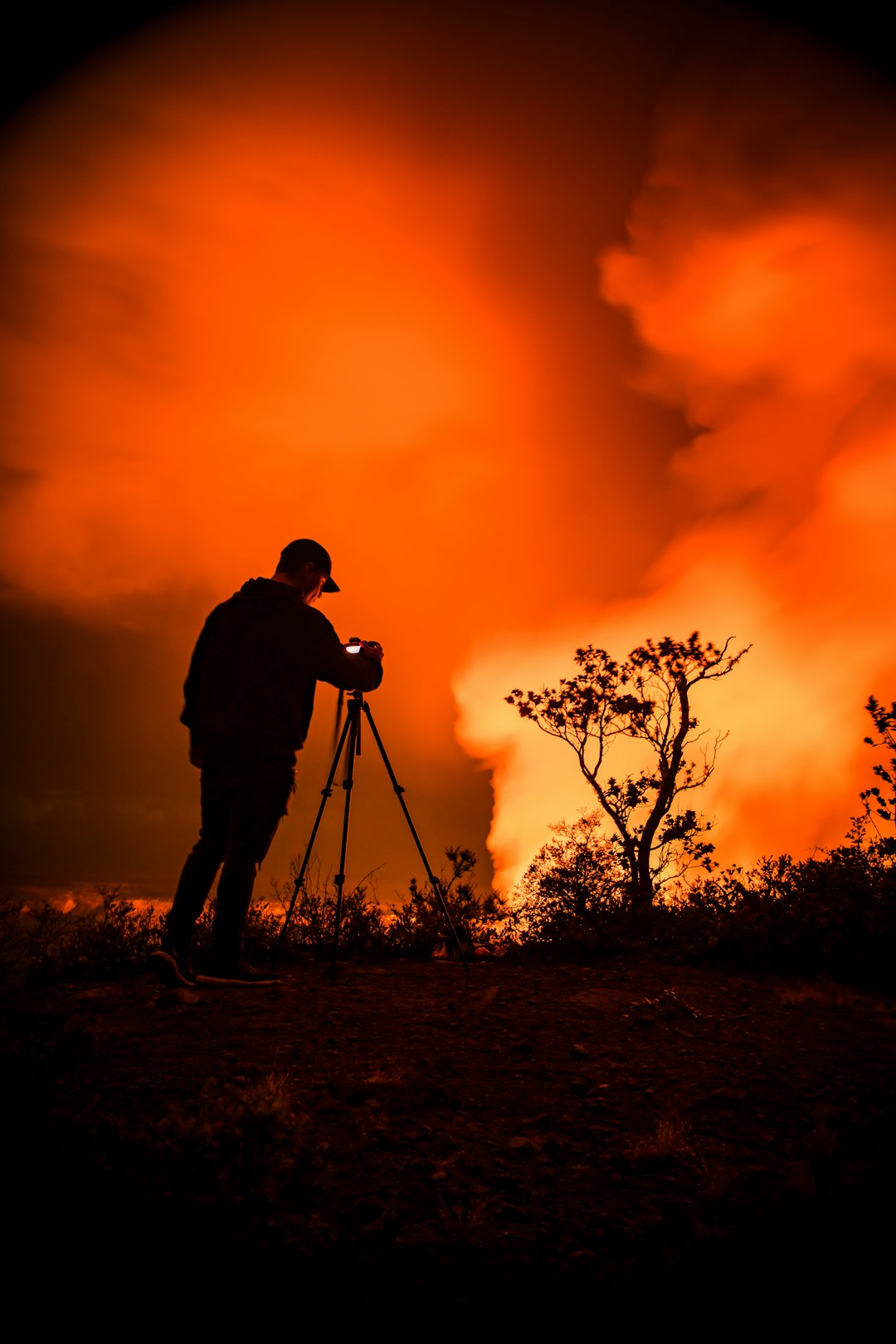 silhouette of man holding camera