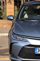 Side profile of a silver hatchback under bright daylight
