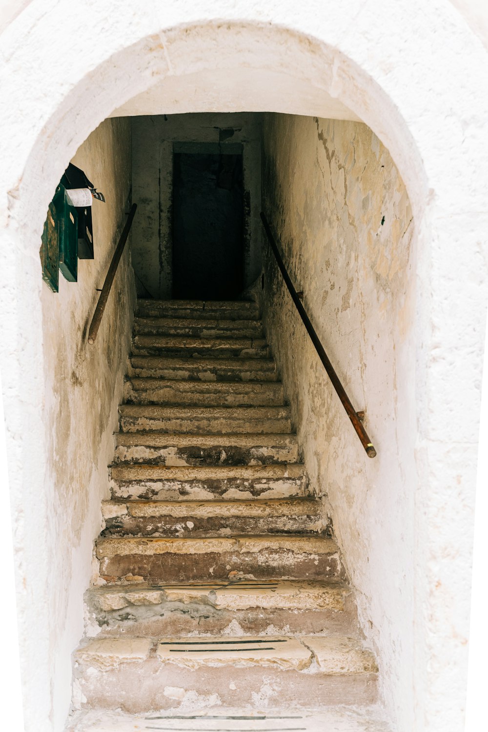 gray concrete staircase with green and white textile