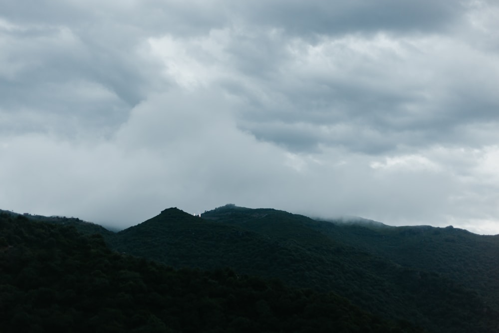 green mountain under white clouds during daytime