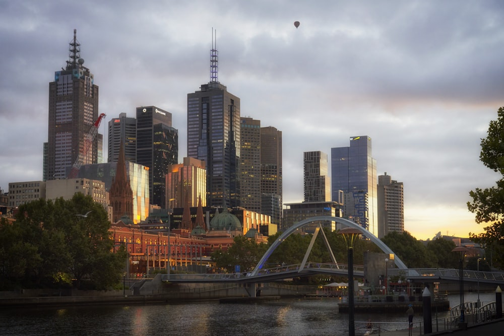 city skyline with bridge and body of water during daytime