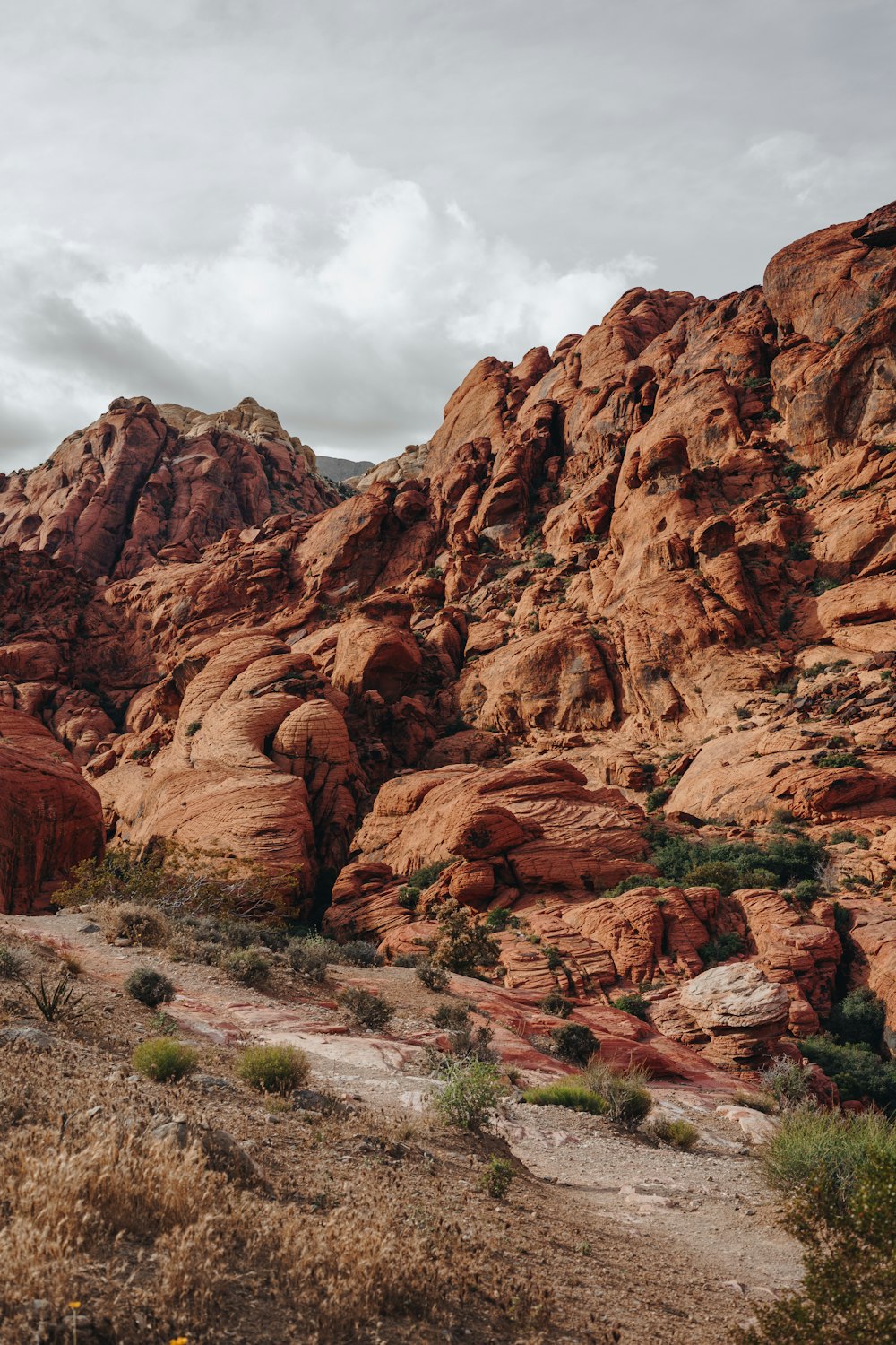 brown rock formation under white clouds during daytime