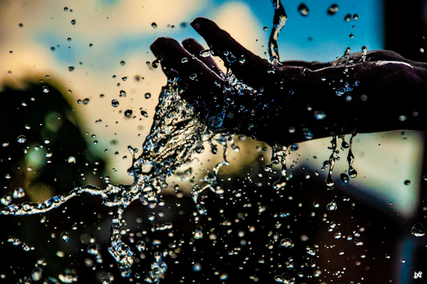 water droplets on persons hand