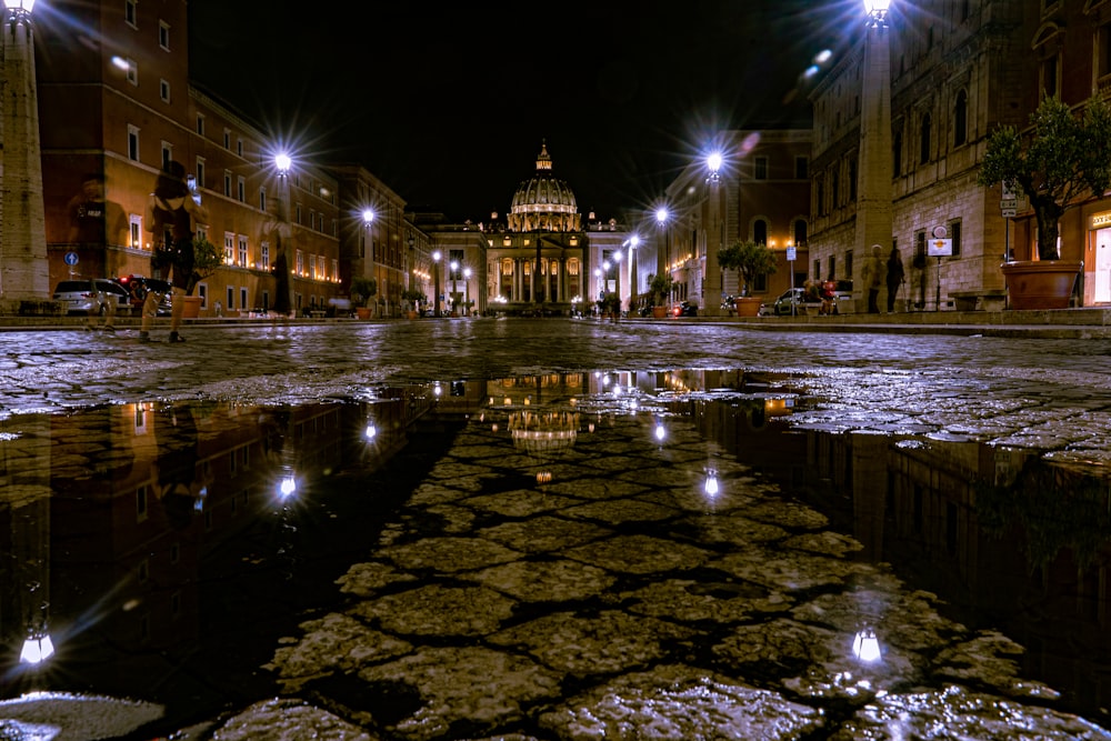 people walking on sidewalk during night time