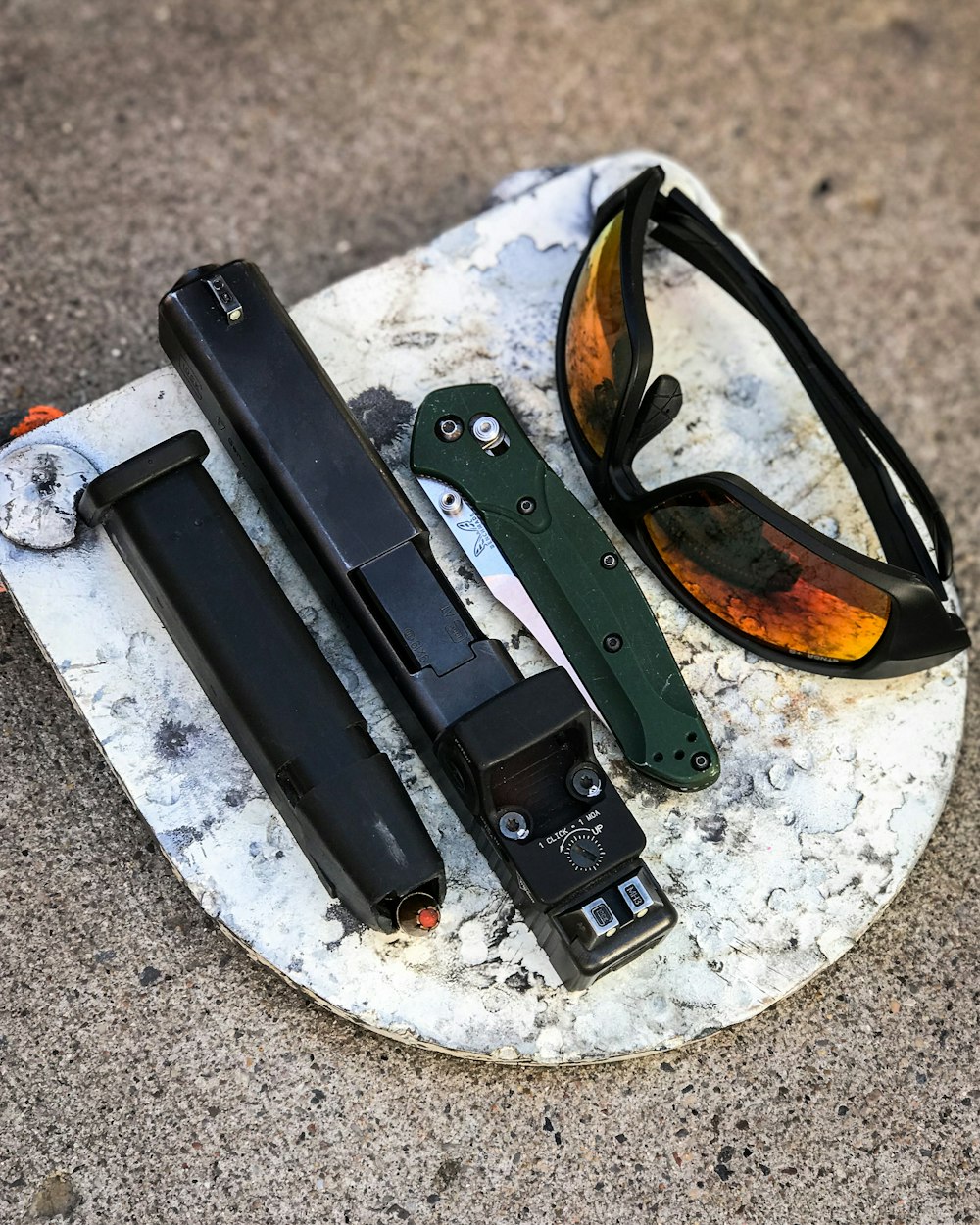 black framed sunglasses on gray and white marble table