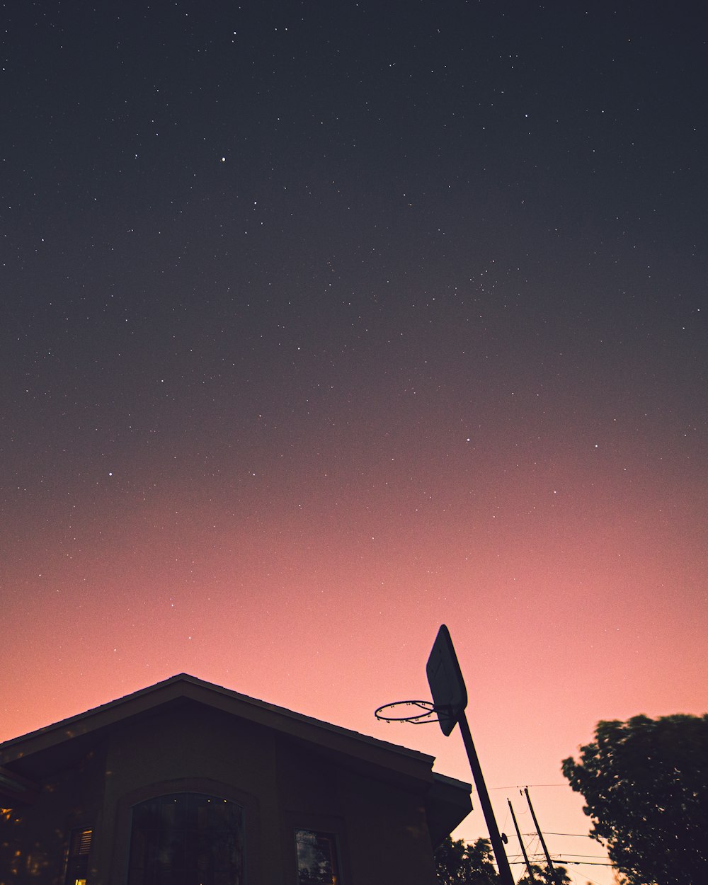 silhouette of house under blue sky during night time