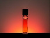clear glass bottle with orange liquid