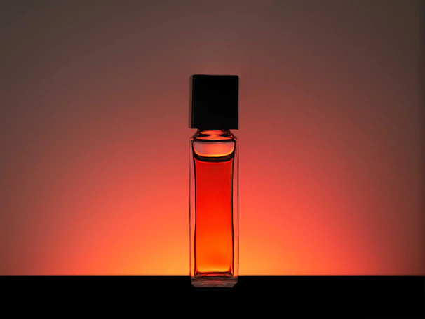 clear glass bottle with orange liquid