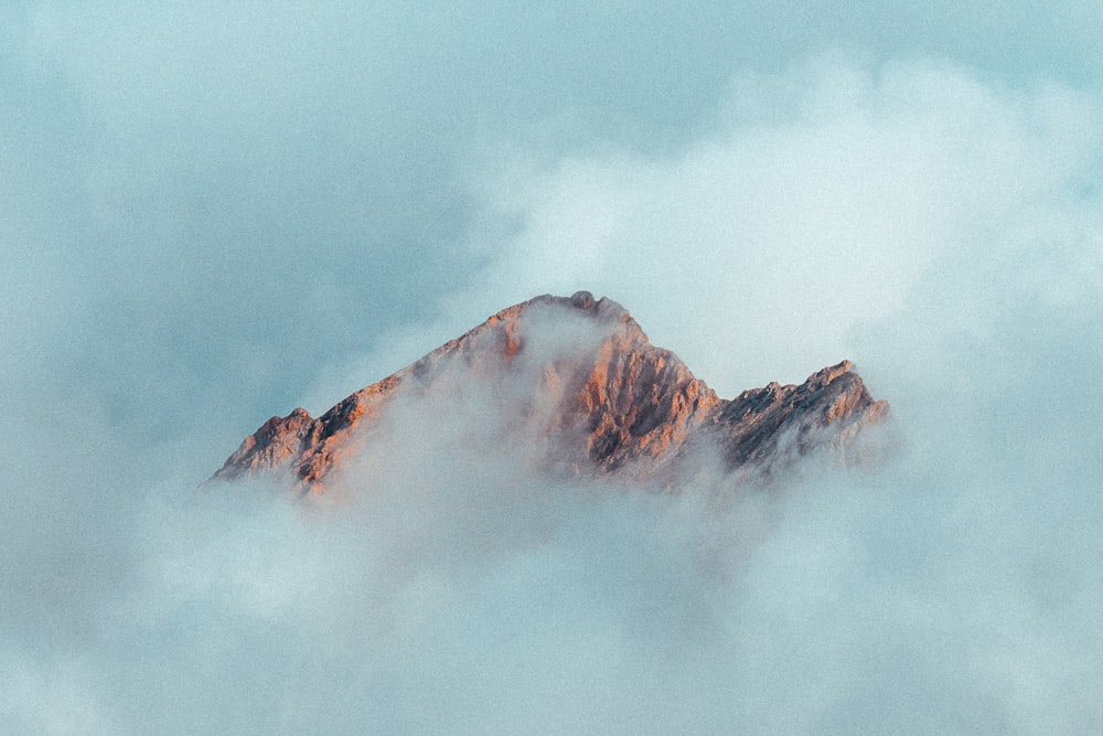 brown mountain under white clouds