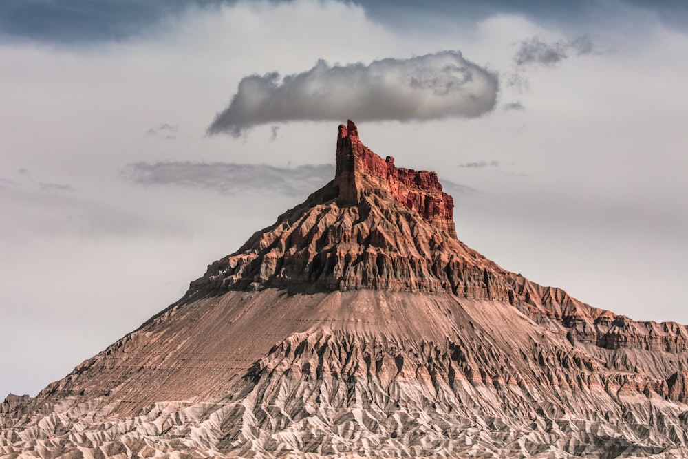 brown rock formation under white clouds during daytime