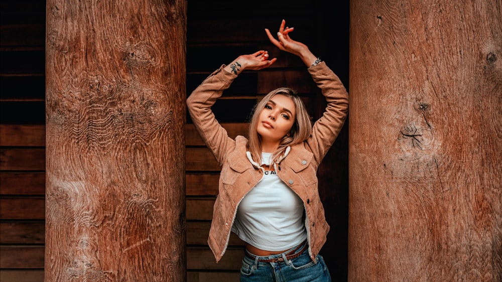 woman in brown leather jacket and blue denim jeans