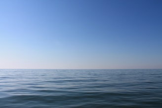 blue ocean water under blue sky during daytime